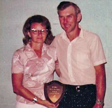 Betty and Dale holding the service award